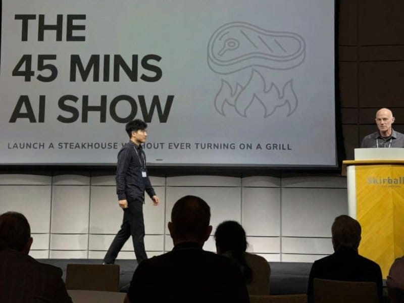 Sam Wong presenting AI training on stage